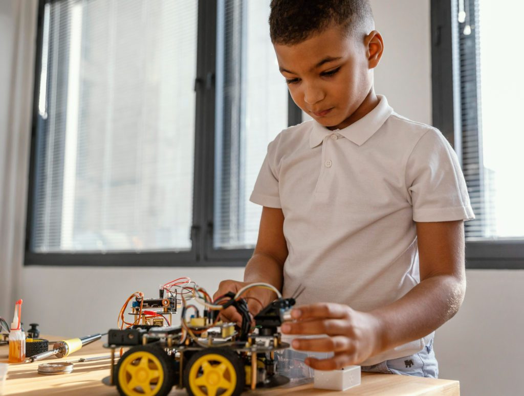 Boy building a robot kit. 