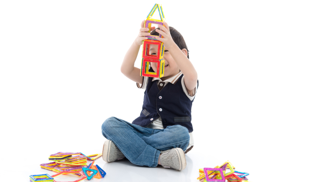 Child playing with magnetic tiles. 