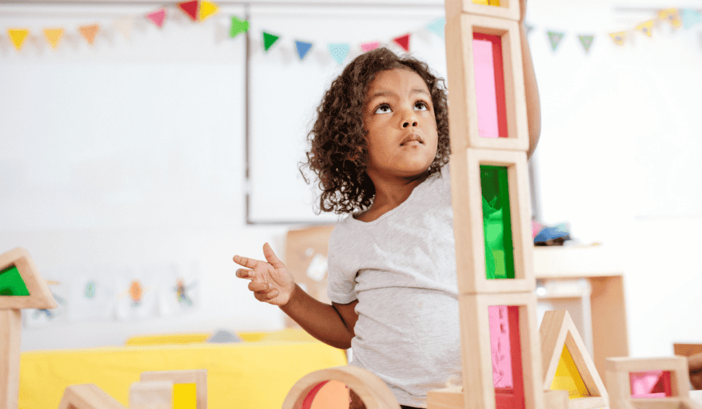 Girl building with magnetic blocks.