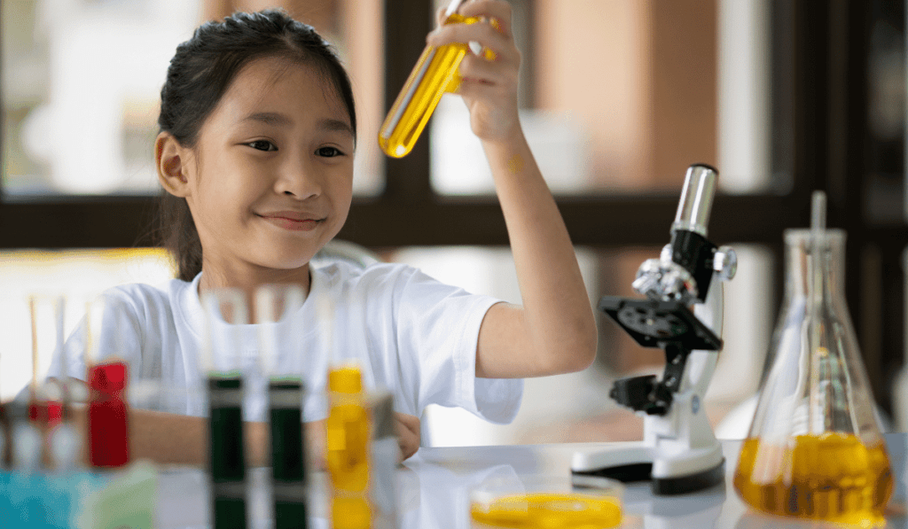 Girl using a chemistry set. 