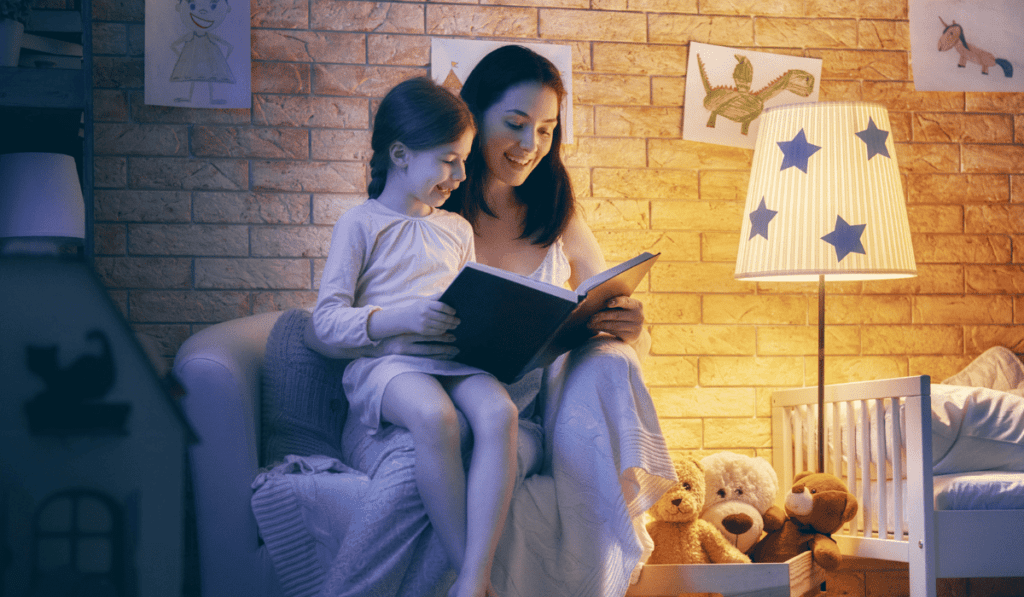 Mom reading a stem bedtime book to daughter. 