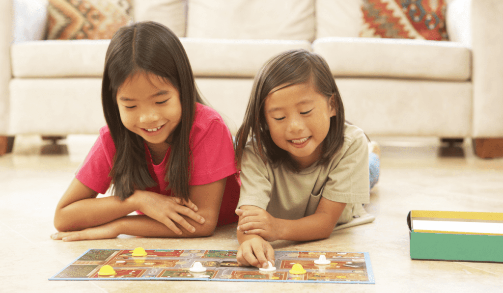 Image of two girls playing a board game. 