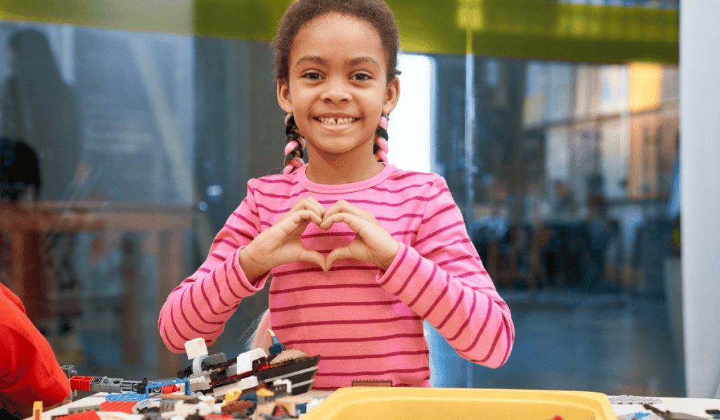 Image of a girl showing her love for robot kits. 