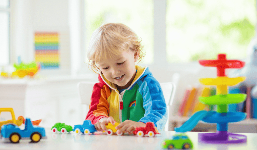 Happy child playing with open-ended toys. 