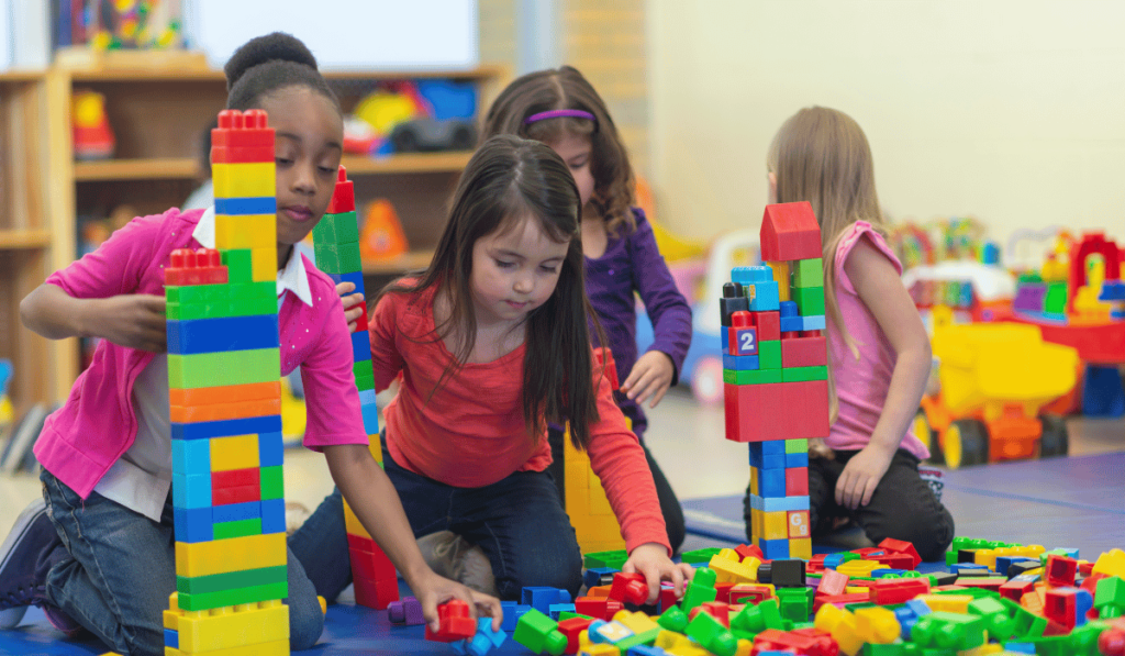 Group of kids playing with open-ended mega blocks. 