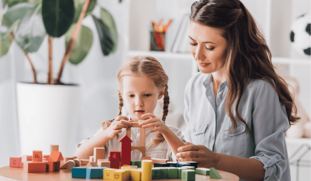 Mother and daughter playing with blocks. 