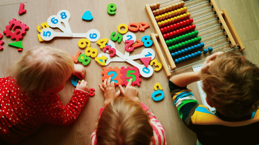 Toddlers playing with math games and puzzles. 